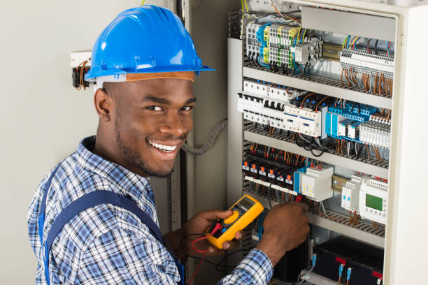Electrician working on electrical panel